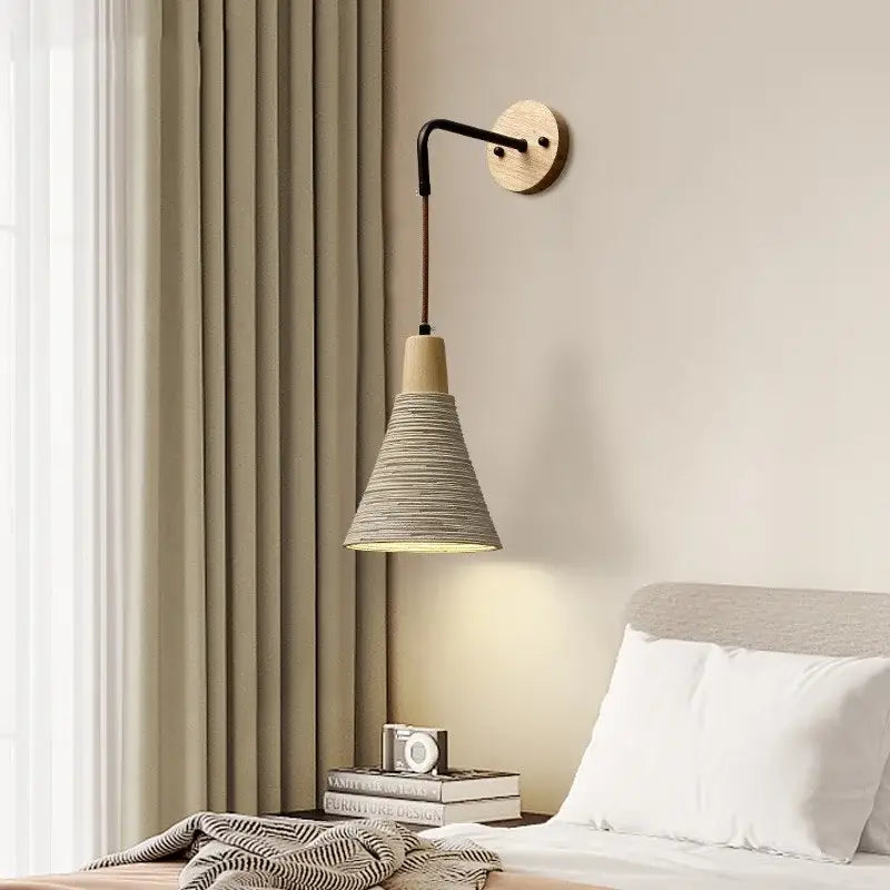 Minimalist decorbites led cement wall light with black curved arm, wood base, and woven gray rope conical shade