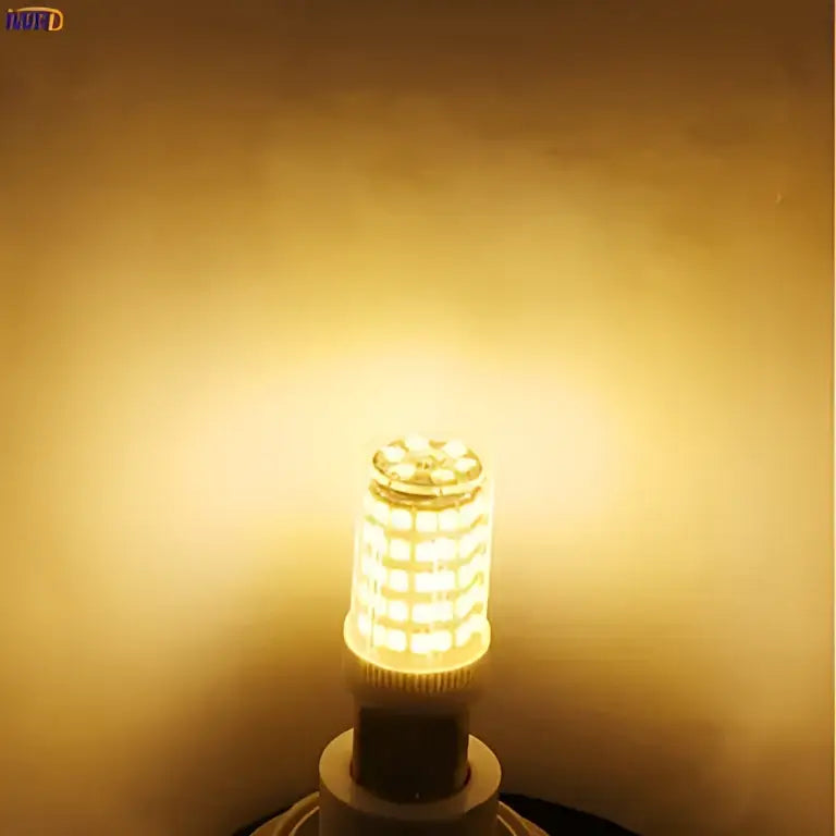 Warm golden-yellow decorbites led ceramic bi-pin bulb with cylindrical design and visible filament structure 4w dimmable