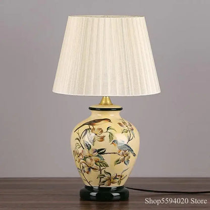 Cream-colored decorbites led ceramic table lamp with hand-painted birds and flowers and pleated off-white shade
