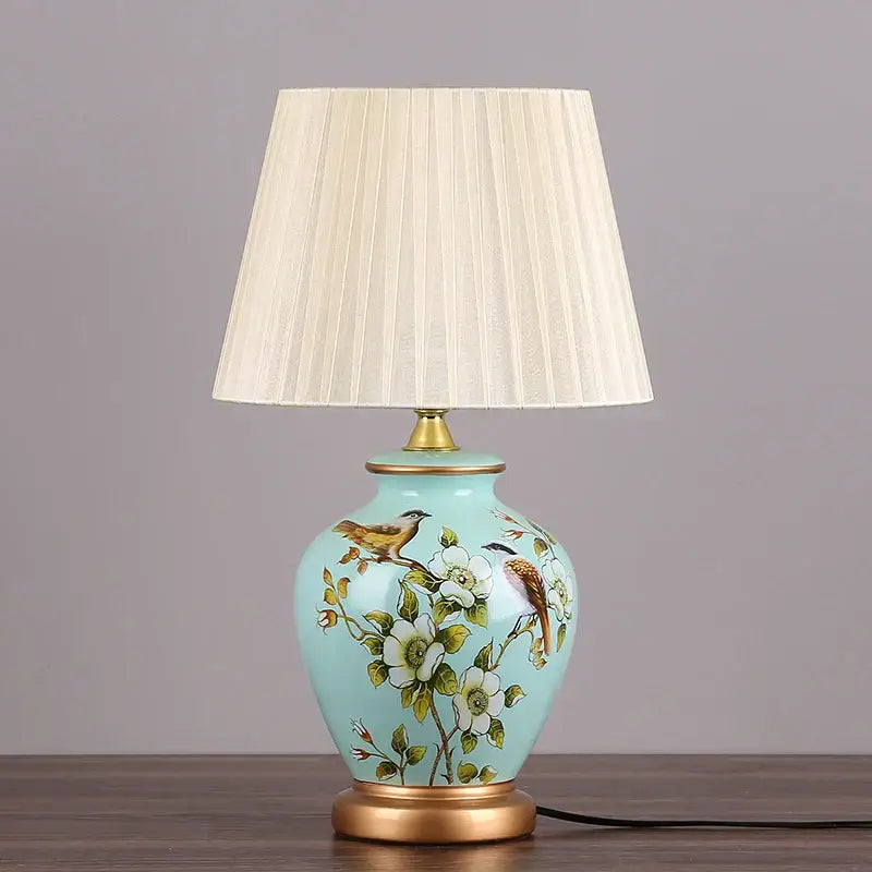 DecorBites led ceramic table lamp in light blue with hand-painted birds white flowers and gold-toned metal accents