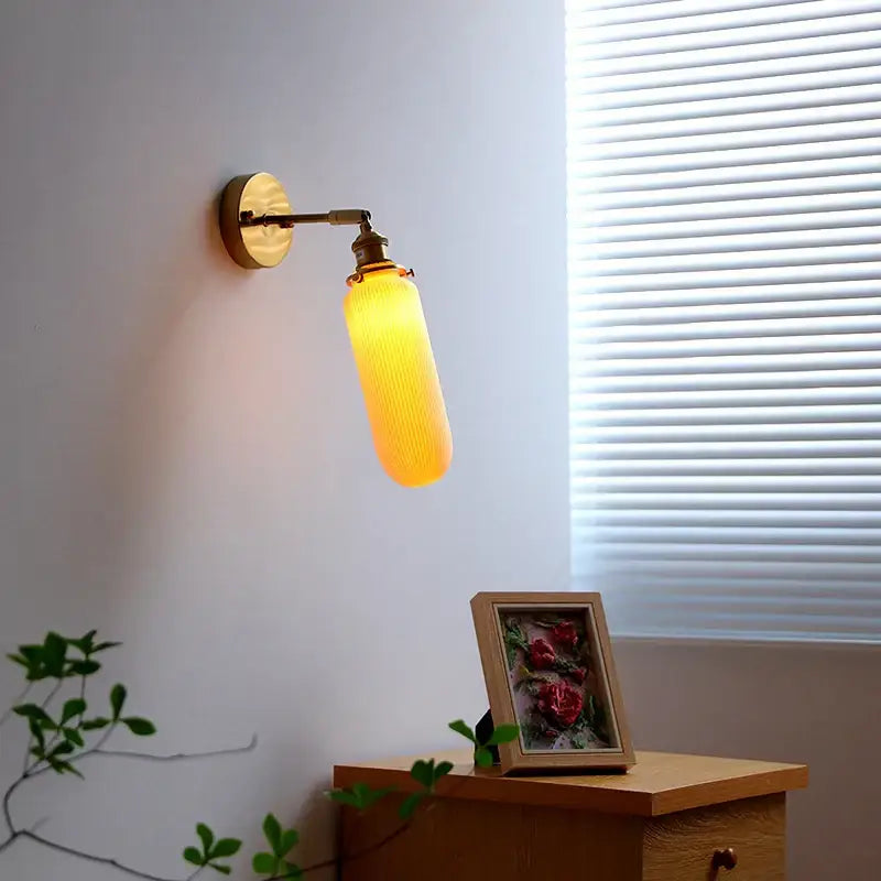 Warm amber glass decorbites led ceramic wall sconce with brass-finished mount and knob switch for bedroom bathroom lighting