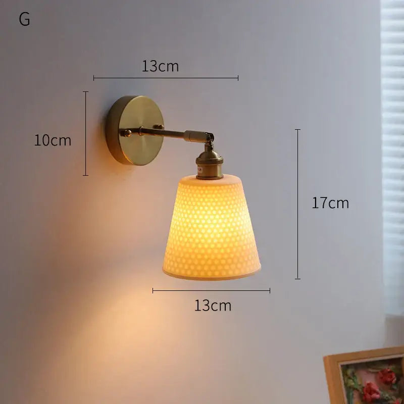 Warm-toned textured glass lampshade on decorbites led ceramic wall sconce with brass finish for bedroom lighting