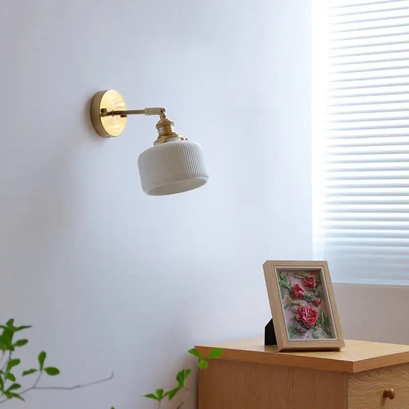 White ribbed ceramic wall sconce with brass arm and knob switch for bedroom and bathroom by decorbites led ceramic