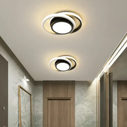 Modern circular decorbites led chandelier with concentric black and white rings and a bright central bulb