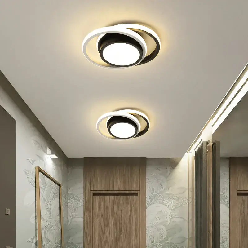 Modern circular decorbites led chandelier with concentric black and white rings and a bright central bulb