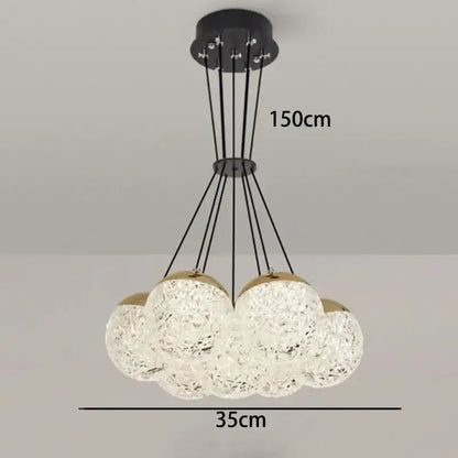 Modern decorbites led chandelier ceiling lamp with clear textured glass spheres and gold accents for chic bedroom lighting