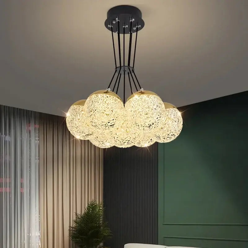 Cloud-shaped DecorBites LED chandelier ceiling lamp with golden crystal mesh globes suspended by black metal rods for chic decor