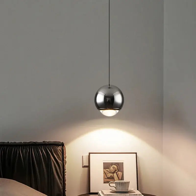 A sleek spherical chrome modern pendant light with minimal design from DecorBites LED chandelier collection