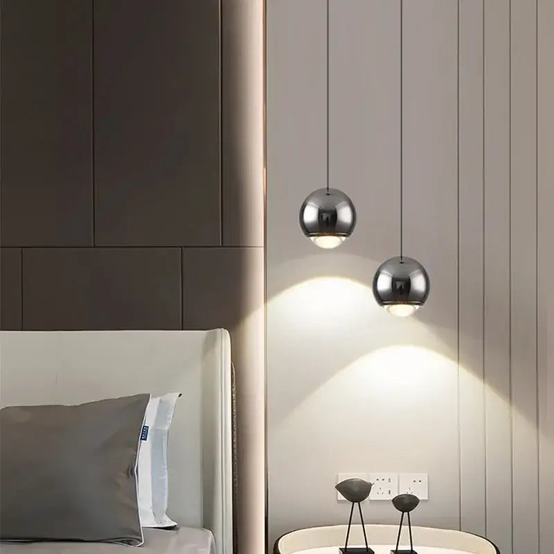 Two sleek spherical chrome pendant lights hanging from ceiling in decorbites led chandelier modern design