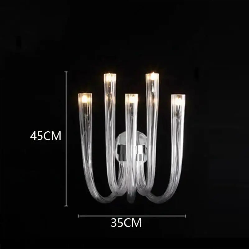 Clear glass decorbites led chandelier lighting fixture with five curved arms and warm glowing lights for bedroom ceiling
