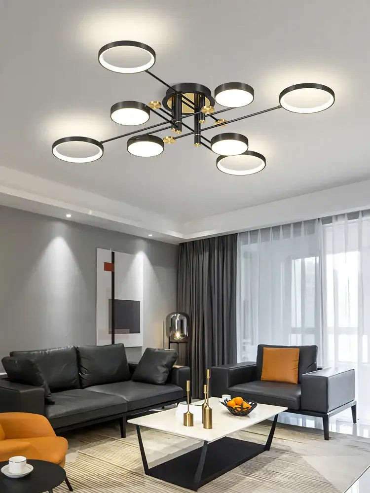 Modern black and gold circular decorbites led chandelier with multiple illuminated rings for living and dining rooms