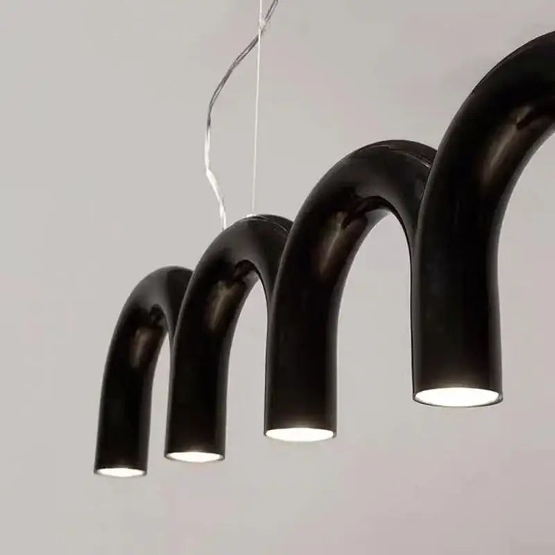 Modern black curved pendant lights with glossy finish and warm interior illumination in decorbites led chandelier design