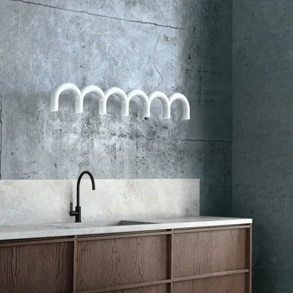White curved pipe-style wall-mounted led chandelier with modern industrial design for living room by decorbites led chandelier