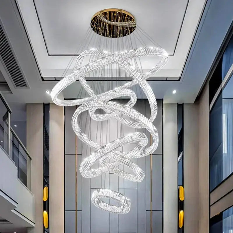 A DecorBites LED chandelier with clear crystal rings and gold ceiling mount for modern bedroom and living room decor lighting