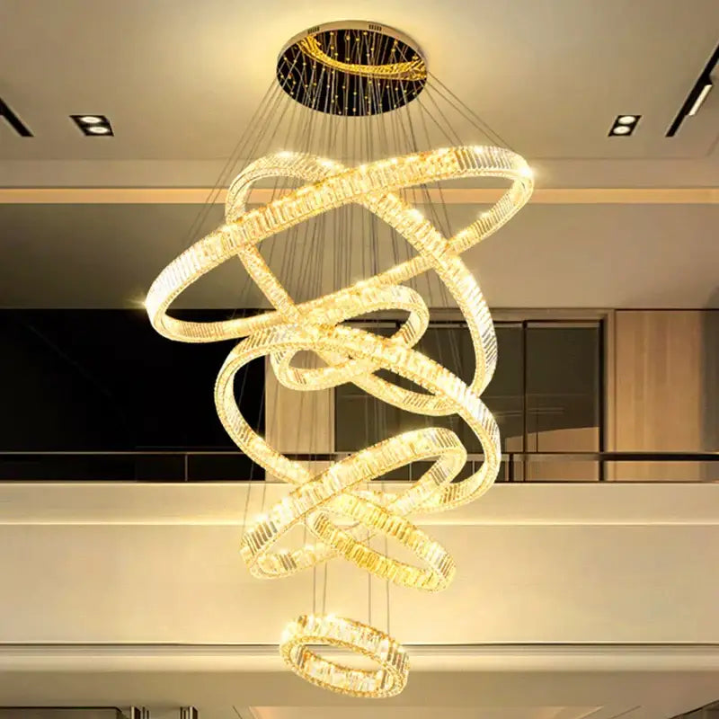 A modern gold-toned DecorBites led chandelier with interlocking rings emitting warm glow for bedroom or living room decor