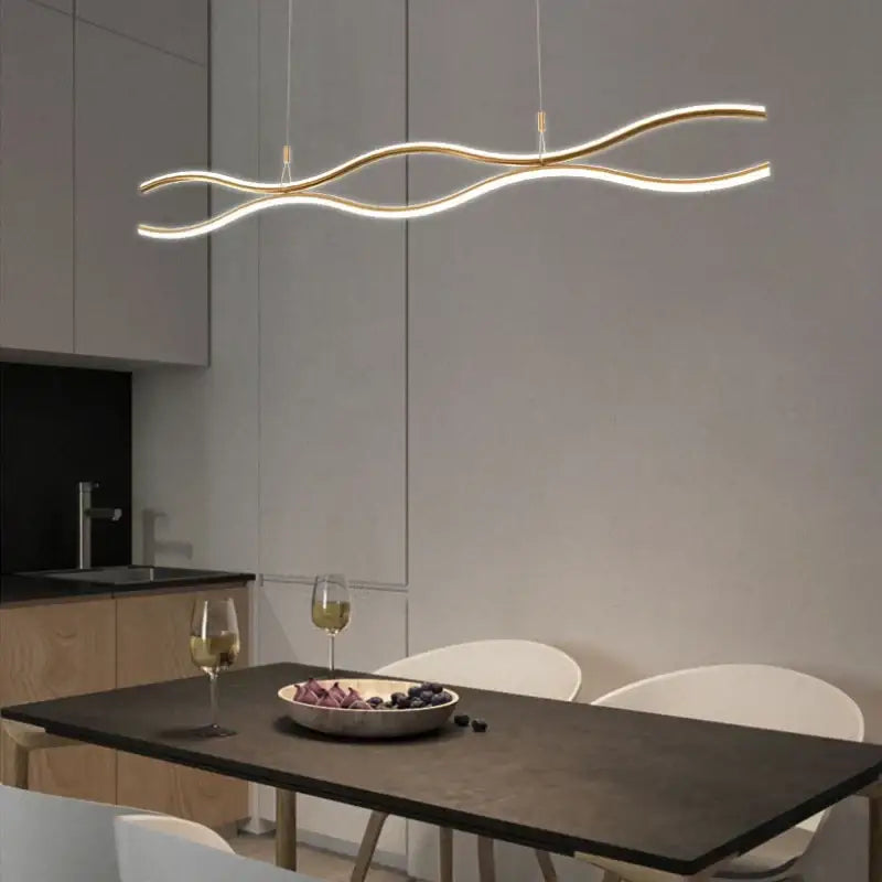 Gold-toned wave-shaped DecorBites LED chandelier pendant light with sleek modern design for dining and bar tables