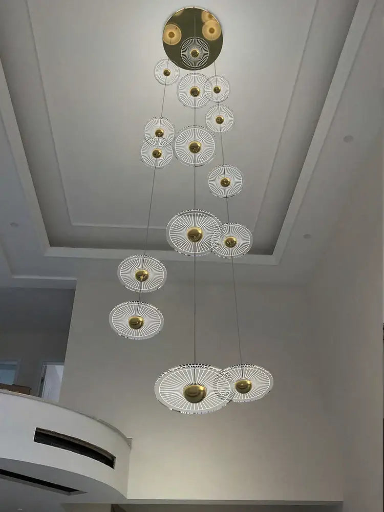 Decorbites led chandelier with tiered circular gold centers and clear glass discs for loft villa staircase lighting