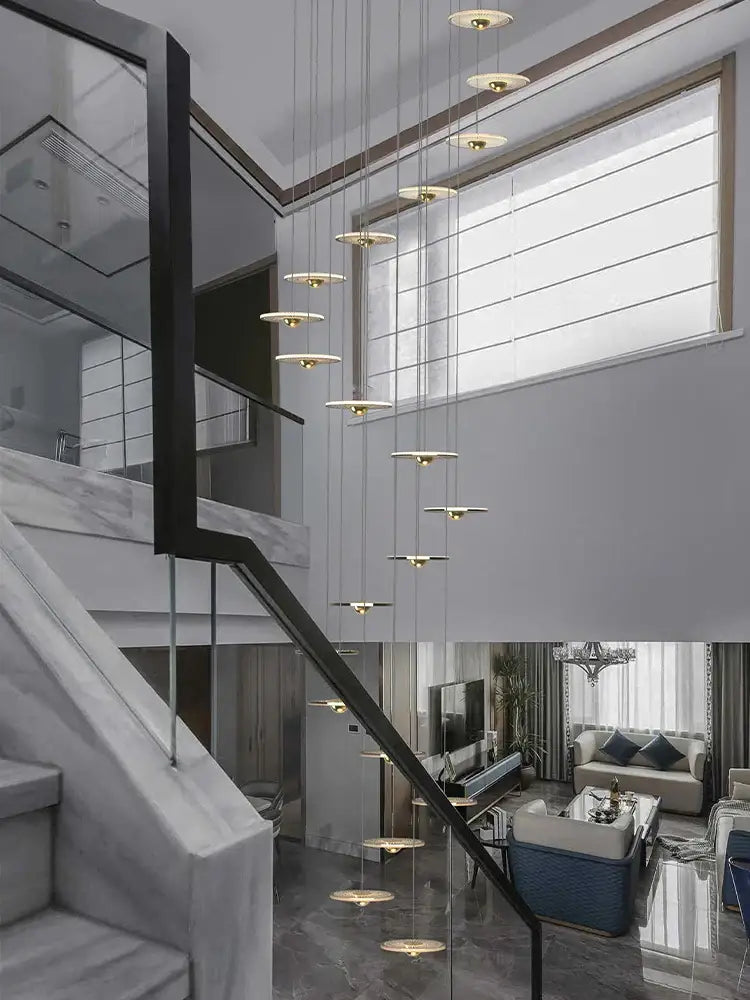 Modern minimalist decorbites led chandelier with circular gold-toned fixtures hanging by thin cables for loft villas