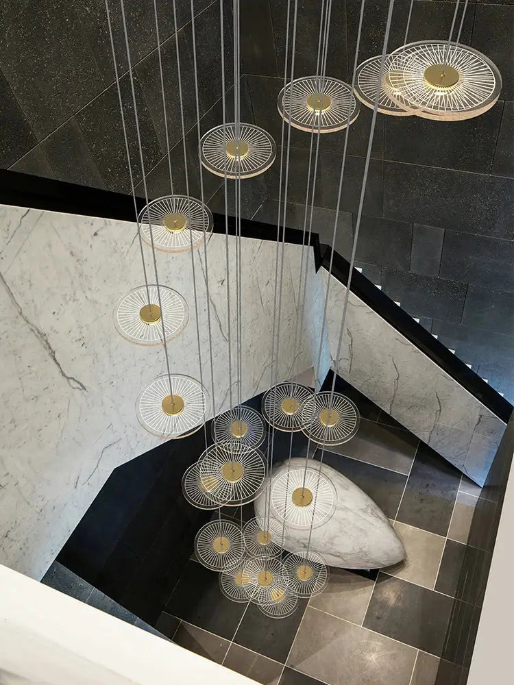 Modern decorbites led chandelier with gold centers and clear wireframe design for revolving staircase lighting