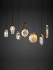 A collection of decorbites led chandelier lighting with clear glass shades gold metal accents and black cords for dining room