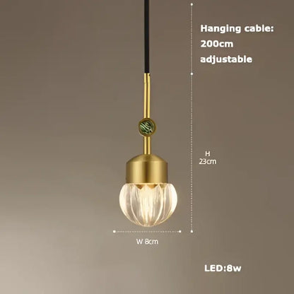 Gold-toned DecorBites LED chandelier lighting with textured faceted glass globe and adjustable black cable for dining room