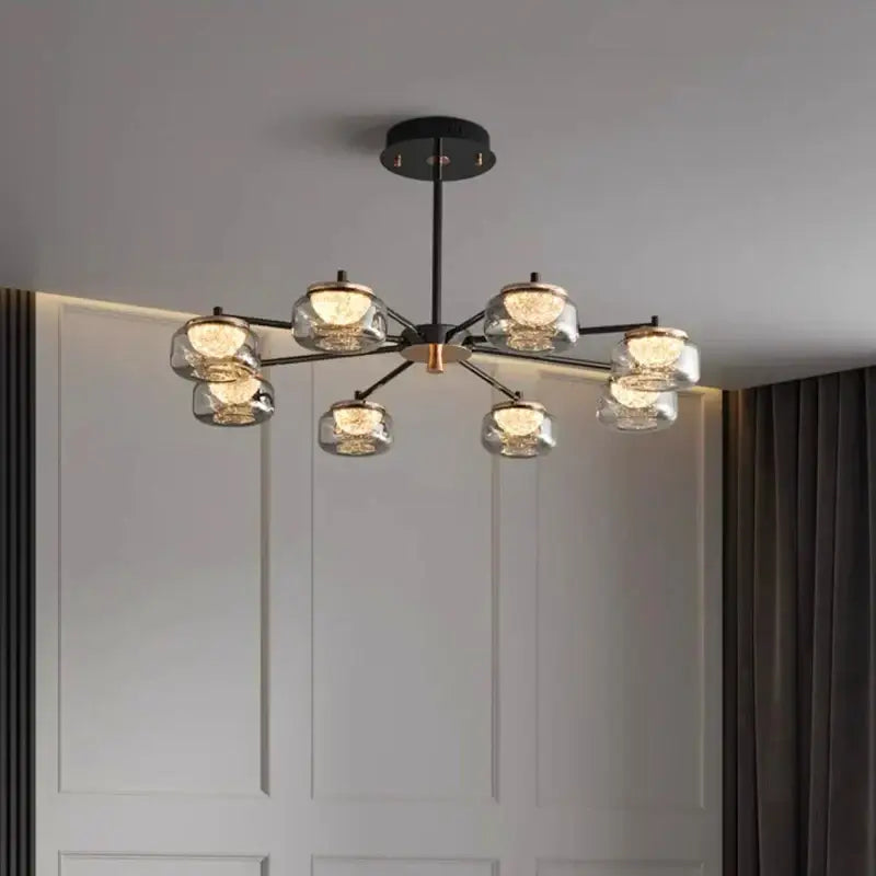 Decorbites led chandelier lighting featuring a modern black and brass frame with six clear glass globe shades for living room