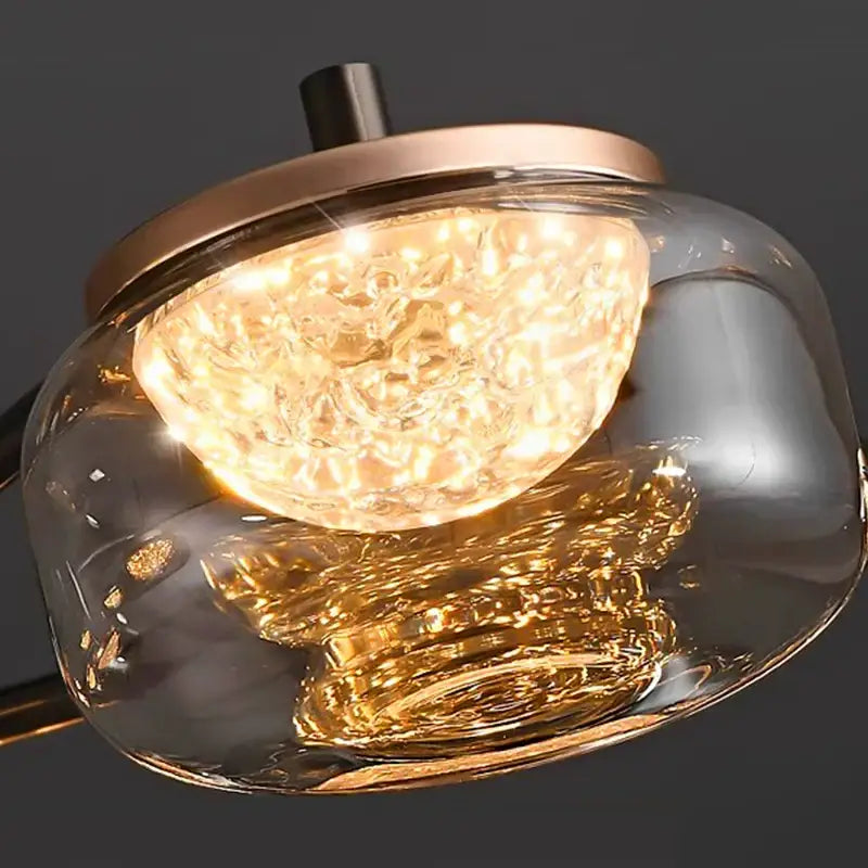 Decorbites led chandelier featuring a modern glass pendant with textured amber-gold interior and rose gold accents
