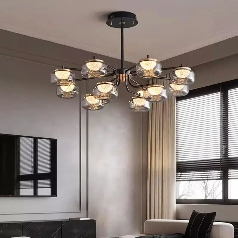 Modern black metal DecorBites LED chandelier lighting with clear glass globe shades emitting warm light for dining room