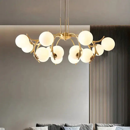 Gold-toned decorbites led chandelier lighting with frosted glass globes in a branching design for living room decor