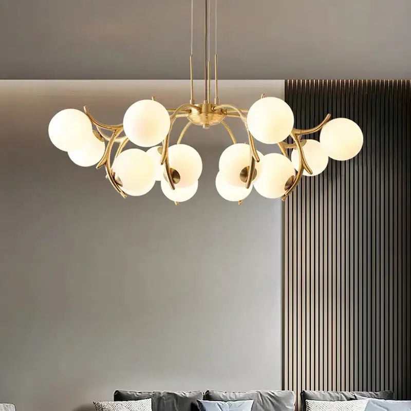 Gold-toned decorbites led chandelier lighting with frosted glass globes in a branching design for living room decor