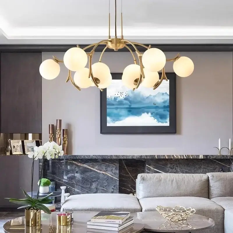 Gold-toned DecorBites LED chandelier lighting with multiple frosted glass globe shades for living room and bedroom décor