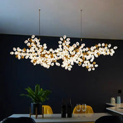 Gold-toned decorbites led chandelier with clusters of frosted glass globes for living room and bedroom lighting decor