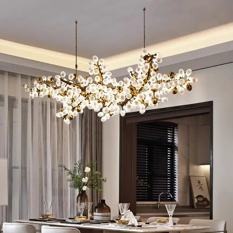 Gold-toned decorbites led chandelier lighting with frosted glass globes resembling blossoms for living room decor
