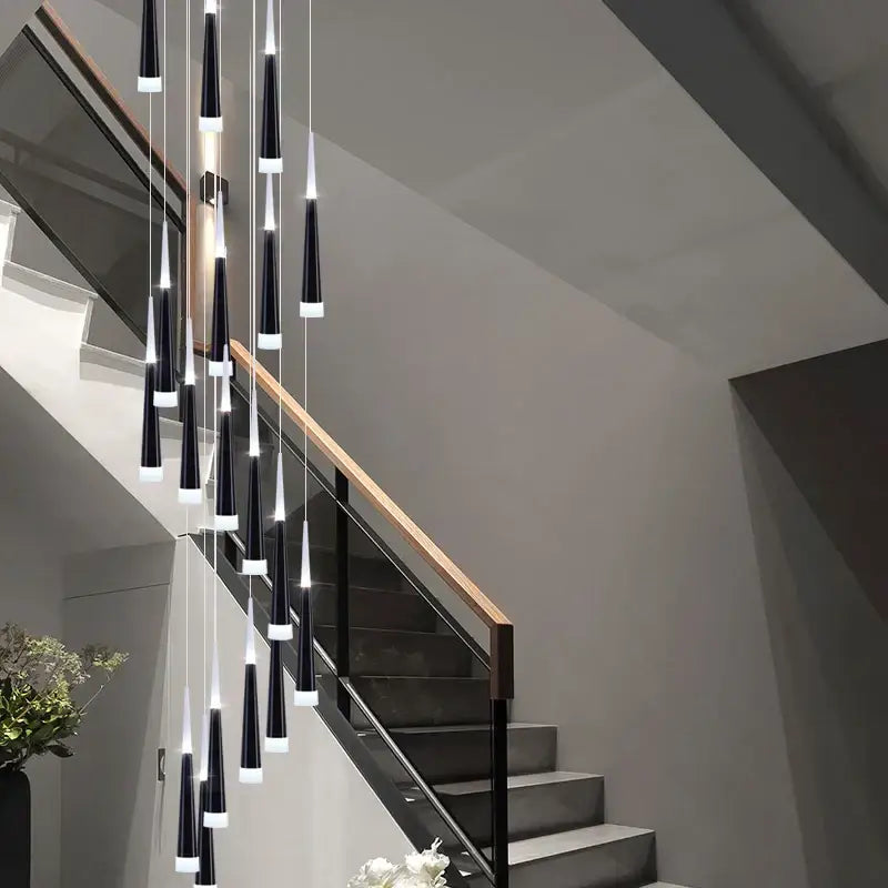Modern black and white conical decorbites led chandelier lighting hangs in cascading arrangement above staircase for villas