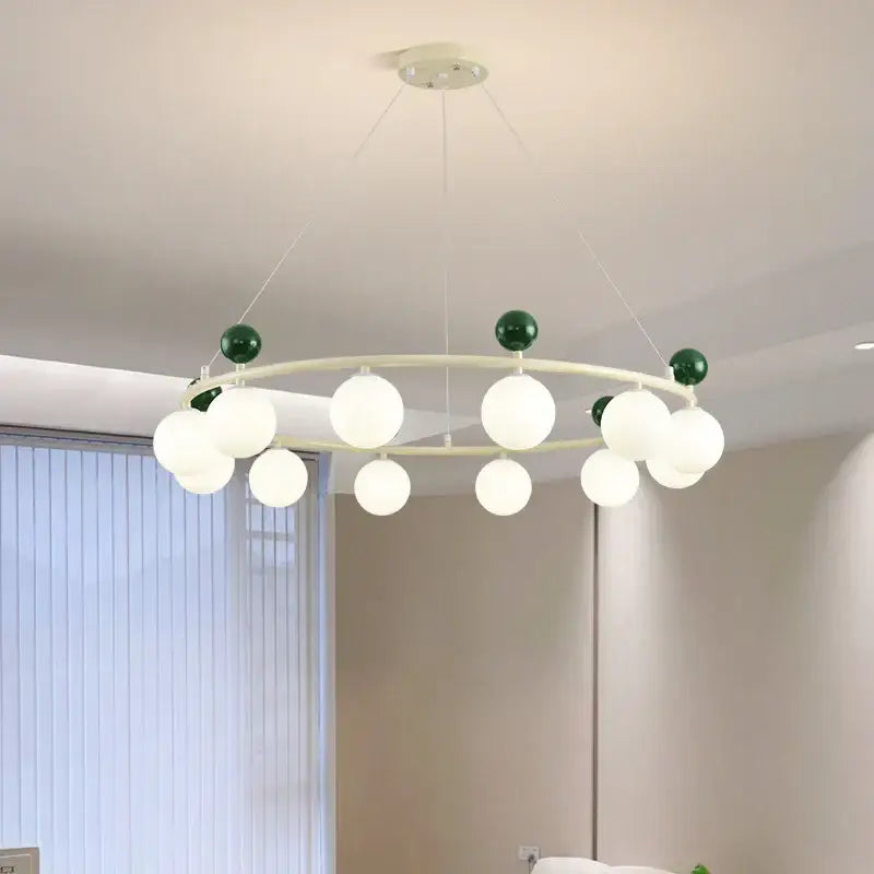 Modern circular decorbites led chandelier with white metal frame, frosted glass globes, and dark green decorative spheres