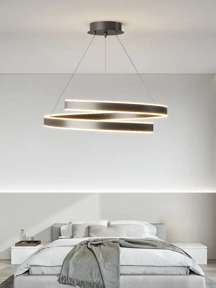 Modern minimalist led chandelier lights featuring two interlocking brushed metal rings with warm led lighting for indoor use