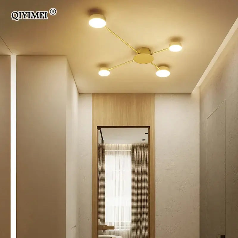 Gold-colored decorbites led chandelier featuring four circular bulbs in a starburst pattern for modern indoor lighting