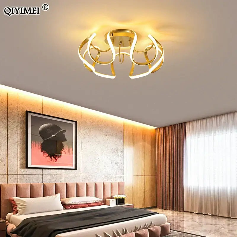 Gold-toned decorbites led chandelier with sleek curved led rings and central base for modern indoor lighting