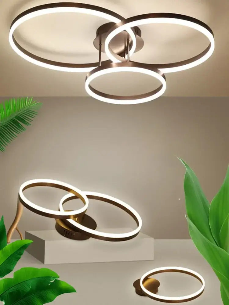 Modern bronze-finished decorbites led chandelier with three interlocking circular rings for bedroom and dining room lighting