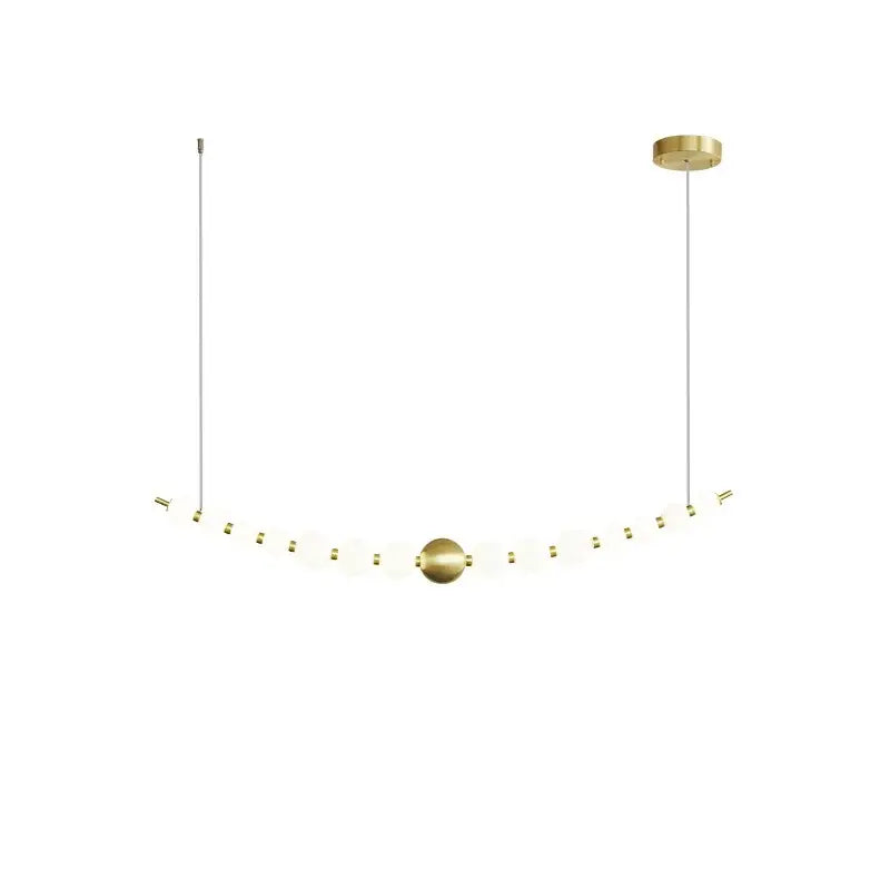 A modern gold-toned DecorBites led chandelier necklace lighting with frosted glass spheres for dining rooms