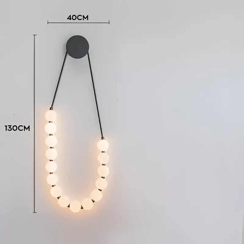 Modern black decorbites led chandelier featuring warm glowing spherical bulbs in an elegant u-shape for dining room lighting