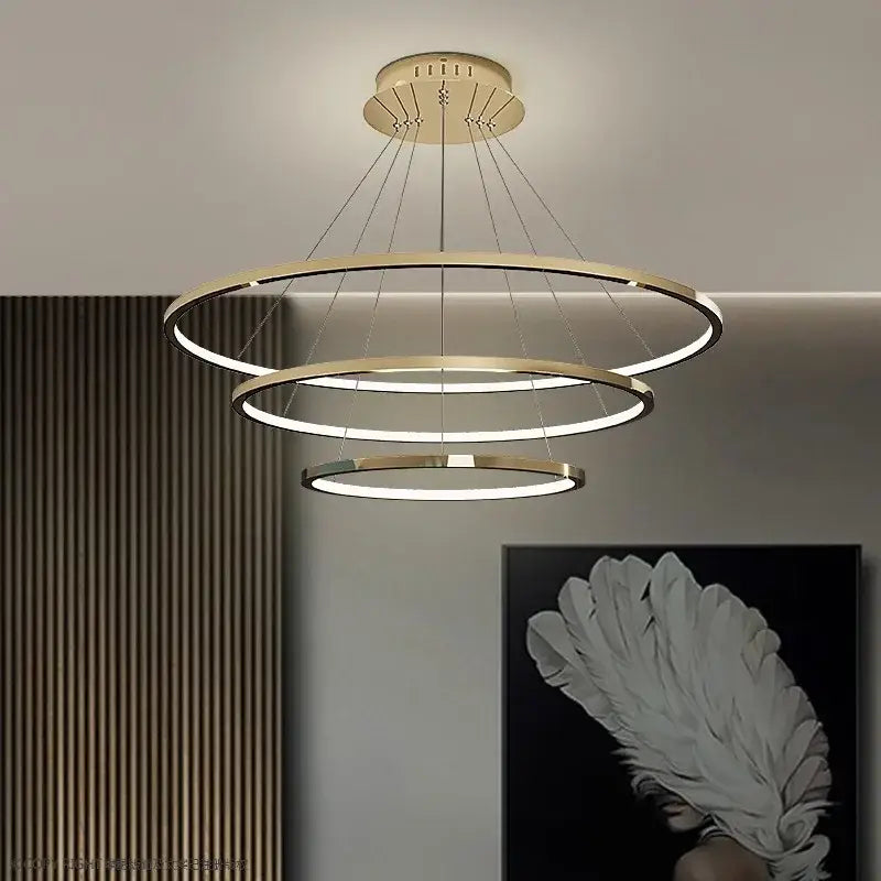 Modern gold-toned triple-ring decorbites led chandelier pendant light with sleek minimalist design for indoor lighting