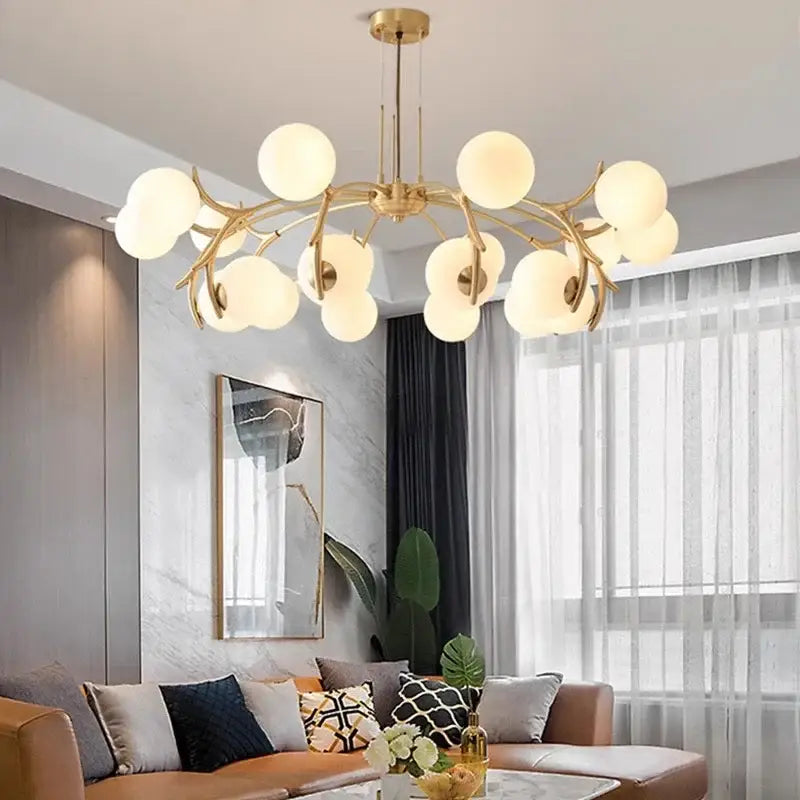 Gold-toned decorbites led chandelier pendant lamp with frosted glass globes in a branching design for living room lighting