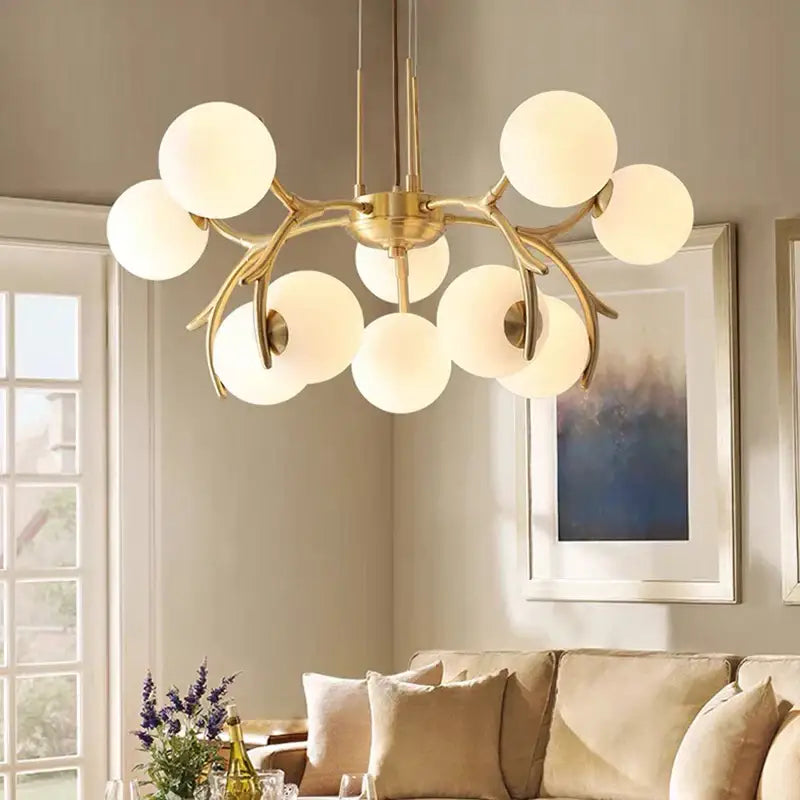 Gold-toned decorbites led chandelier pendant lamp with frosted glass globes in organic design for living room lighting