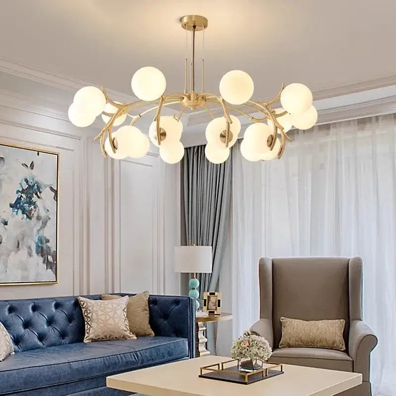 Gold-toned decorbites led chandelier pendant lamp with frosted glass globes in a branching design for living room lighting