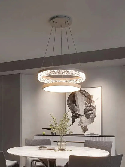 Modern DecorBites led chandelier pendant light with sleek double-ring design, clear crystal accents, and warm diffuser