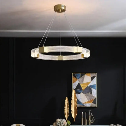 Gold-toned decorbites led chandelier with modern circular design, acrylic lampshade, and crystal accents for living spaces