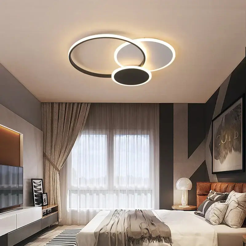 Modern decorbites led chandelier with three interlocking black and white rings emitting warm glow for living room use