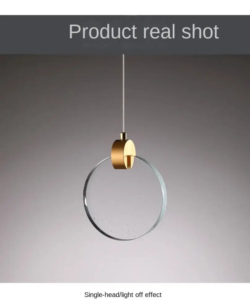 Modern minimalist DecorBites™ led crystal pendant light with gold-toned circular fixture and clear glass ring for bedroom and bathroom