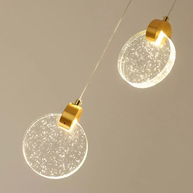 Two modern led crystal pendant lights with gold metal fixtures and translucent glass shades for bedroom and bathroom use